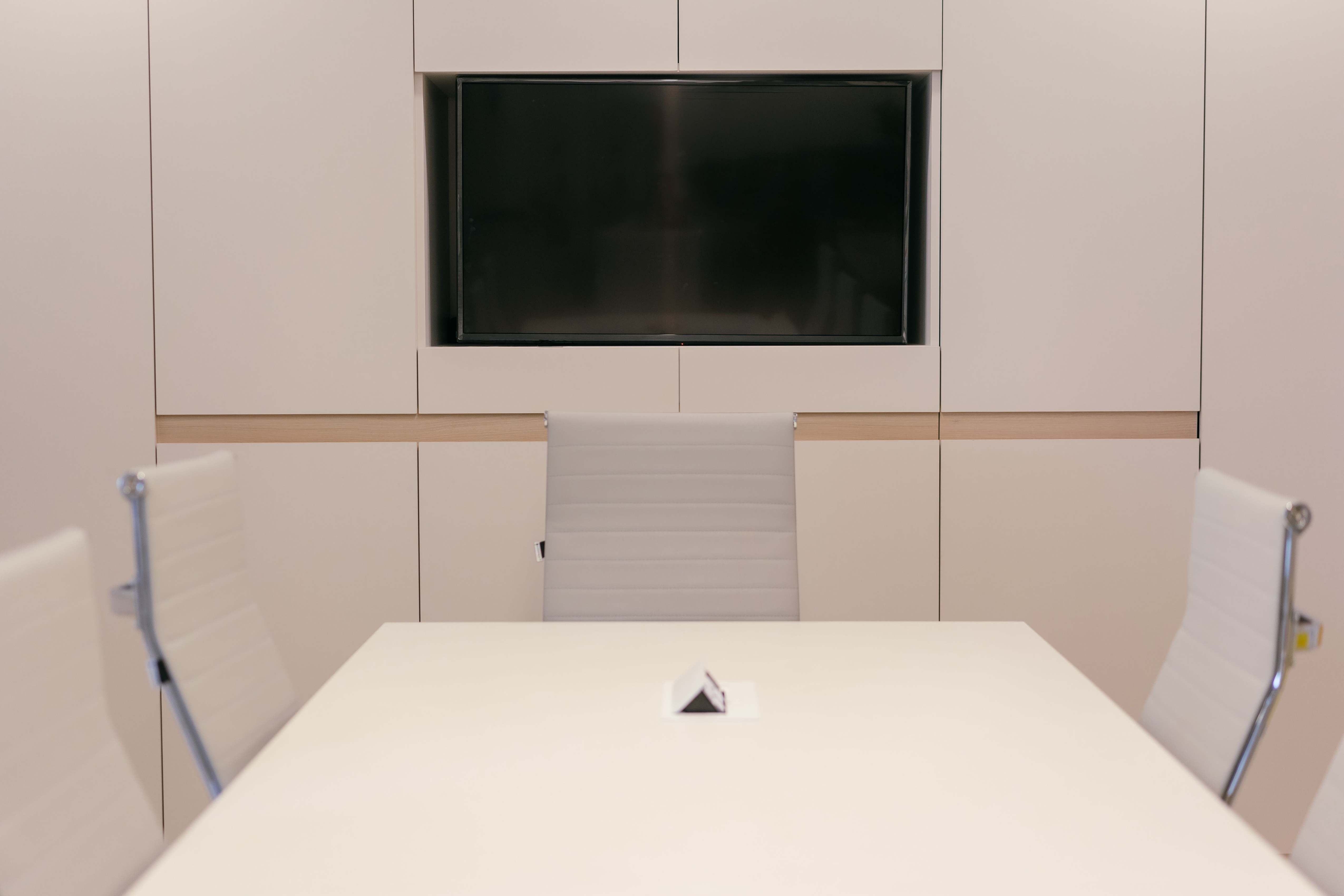 Office meeting room with whiteboard for project planning, modern conference room with white furniture and technology setup